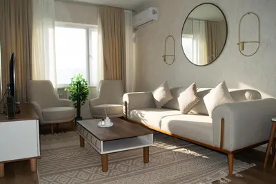 a living room with a white couch and a mirror at Luxe Suite AY37 in Eskiömerler