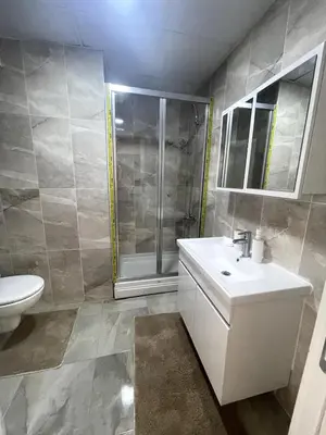 a bathroom with a toilet and a sink and a shower at Luxe Suite AY37 in Eskiömerler