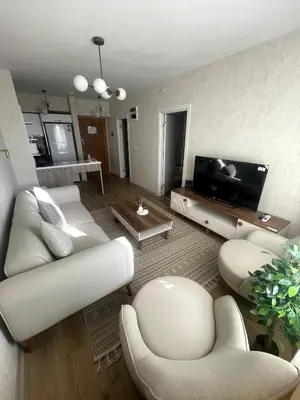 a living room with white furniture and a flat screen tv at Luxe Suite AY37 in Eskiömerler