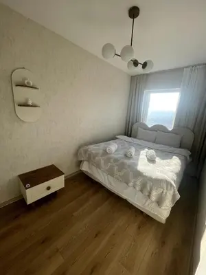 a small bedroom with a bed and a window at Luxe Suite AY37 in Eskiömerler