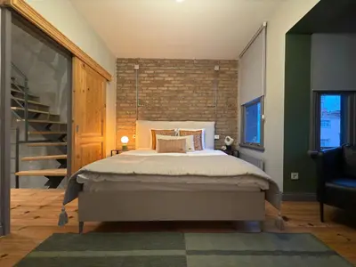 a bedroom with a bed with a brick wall at Stunning Private House in Balat in Istanbul