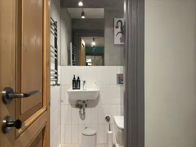 a bathroom with a sink and a toilet and a mirror at Stunning Private House in Balat in Istanbul