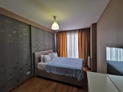 a small bedroom with a bed and a television at CTS Elysium Residence Taksim in Istanbul