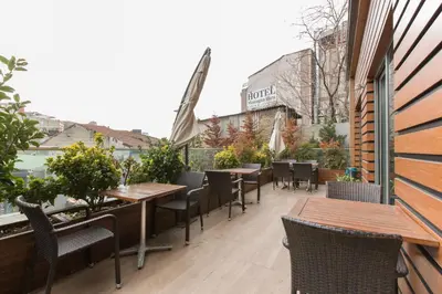 a patio with tables and chairs on a balcony at CTS Elysium Residence Taksim in Istanbul