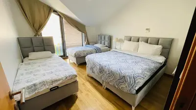 a bedroom with two beds and a window at CTS Elysium Residence Taksim in Istanbul