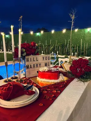 a table with a cake and a sign that reads will you marry me at Lilyum garden house&organization in Söylemiş