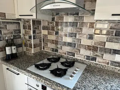 a kitchen counter with a stove top in a kitchen at Lilyum garden house&organization in Söylemiş
