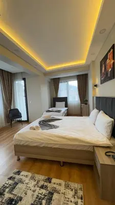 a bedroom with a large bed in a room at Lions Boutique Hotel in Altınova