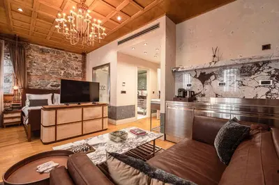 a living room with a couch and a tv at Stone Inn Galata in Istanbul