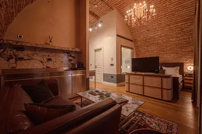 a large living room with a couch and a television at Stone Inn Galata in Istanbul