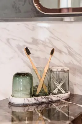 two toothbrushes in a glass container on a table at Stone Inn Galata in Istanbul