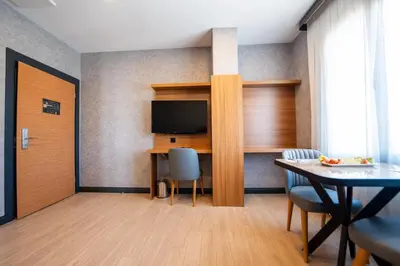 a living room with a table and a television at Educity Hotels & Spa in Istanbul
