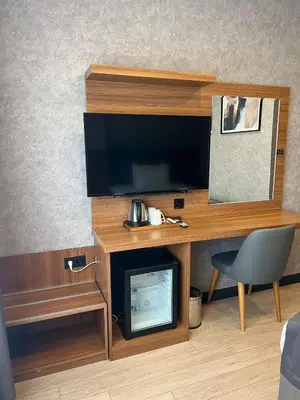 a room with a desk with a television and a chair at Educity Hotels & Spa in Istanbul