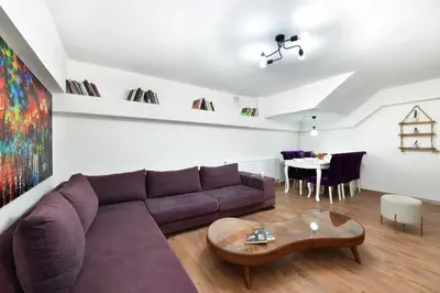 a living room with a purple couch and a table at Historical Wood Dublex Apt at Taksim&Galata in Istanbul