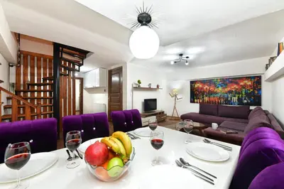 a dining room with a table with a bowl of fruit at Historical Wood Dublex Apt at Taksim&Galata in Istanbul