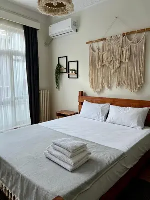 a bedroom with a white bed with towels on it at Old Town Loft in Balat in Istanbul