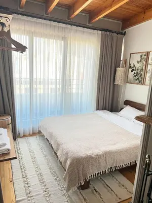 a bedroom with a bed and a large window at Old Town Loft in Balat in Istanbul