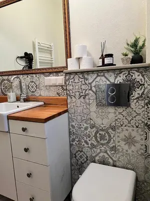 a bathroom with a sink and a toilet and a mirror at Old Town Loft in Balat in Istanbul