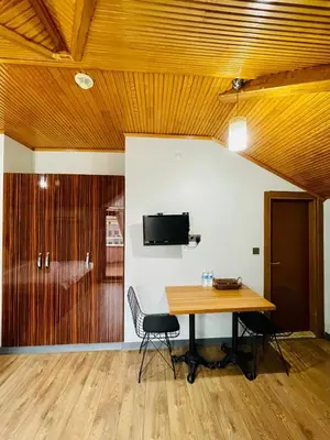 a room with a table and a tv on a wall at Blueway Hotel Residence in Istanbul