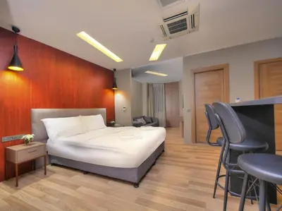 a bedroom with a bed and a table and chairs at Blueway in Istanbul