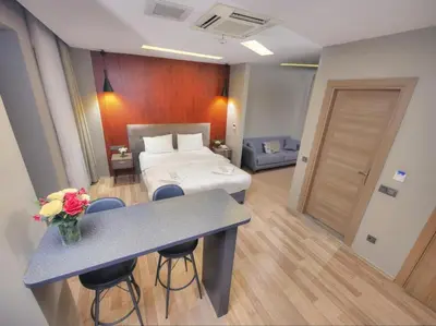 a room with a bed and a table with flowers on it at Blueway in Istanbul