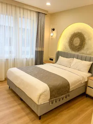 a bedroom with a large bed and a large window at Tophane Mansion Karakoy in Istanbul