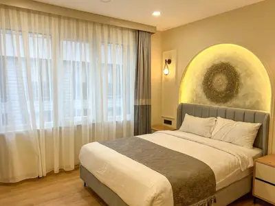 a bedroom with a bed and a large window at Tophane Mansion Karakoy in Istanbul