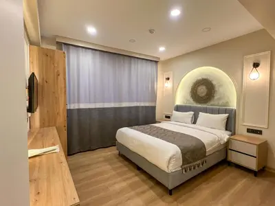 a bedroom with a bed and a large window at Tophane Mansion Karakoy in Istanbul