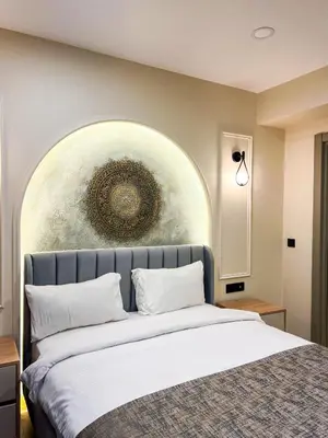 a bedroom with a bed with a painting on the wall at Tophane Mansion Karakoy in Istanbul