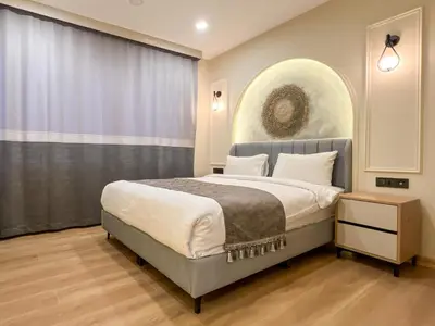 a bedroom with a bed and a large window at Tophane Mansion Karakoy in Istanbul
