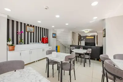 a dining room with tables and chairs and a kitchen at JAMMY Hotel in Istanbul