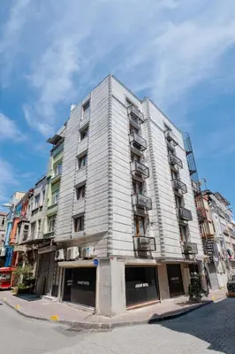 a tall white building on a city street at JAMMY Hotel in Istanbul