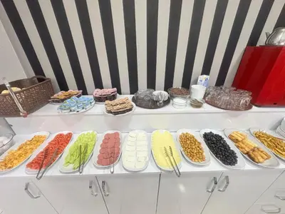 a white shelf with different types of food on it at JAMMY Hotel in Istanbul