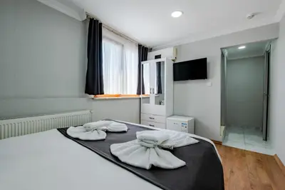 a bedroom with two towels on a bed with a mirror at JAMMY Hotel in Istanbul