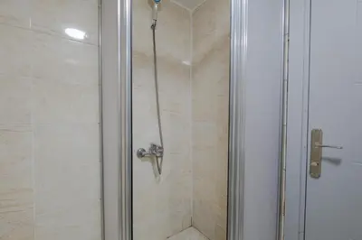 a shower with a glass door and a shower constructorangering at JAMMY Hotel in Istanbul