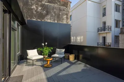a balcony with two chairs and a plant on a building at Fitas Oda Hotel in Istanbul