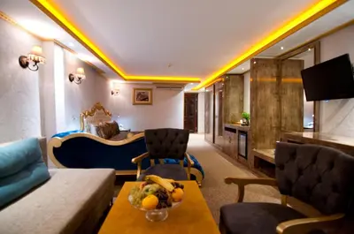 a hotel room with a couch and a table with a bowl of fruit at Grand Ambiance Hotel in Istanbul