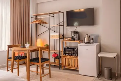 a room with a small table and a refrigerator at Cozy Home in Historic Istanbul in Istanbul
