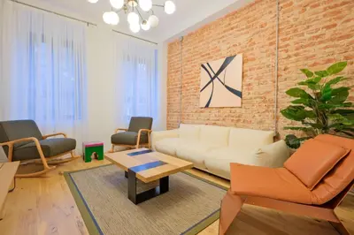 a living room with a white couch and a brick wall at Casa Isabel - Amazing 5Br House in Prime Location in Istanbul