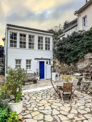 a patio with a table and chairs and a house at Rent the Entire Bosphorus House in Istanbul