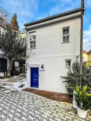 a white house with a blue door at Rent the Entire Bosphorus House in Istanbul