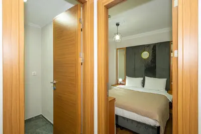 a bedroom with a large bed and a mirror at Aras Life Hotel in Istanbul