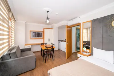 a hotel room with a bed and a couch and a table at Aras Life Hotel in Istanbul