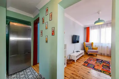 a living room with a refrigerator and a chair at Golden Horn Hidden Haven in Istanbul