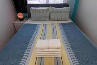 a bedroom with a bed with towels on it at Golden Horn Hidden Haven in Istanbul