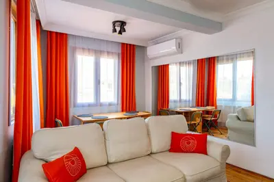 a living room with a white couch and red pillows at Golden Horn Hidden Haven in Istanbul