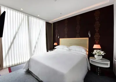 a bedroom with a white bed and a large window at Burgu Arjaan by Rotana Istanbul Asia in Istanbul