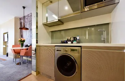 a kitchen with a washing machine and a dining room at Tango Arjaan by Rotana Istanbul Asia in Istanbul
