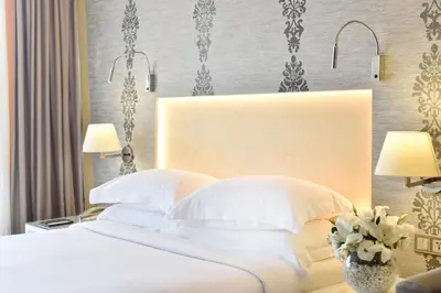 a bedroom with a large bed with white pillows at Tango Arjaan by Rotana Istanbul Asia in Istanbul