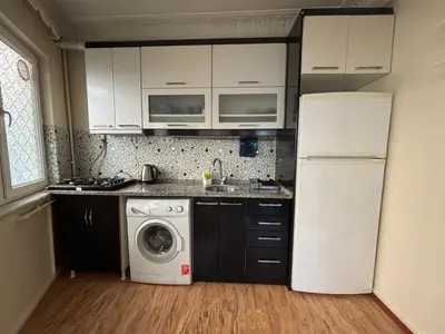 a kitchen with a refrigerator and a washing machine at Istanberry - Joker Apartments in Istanbul